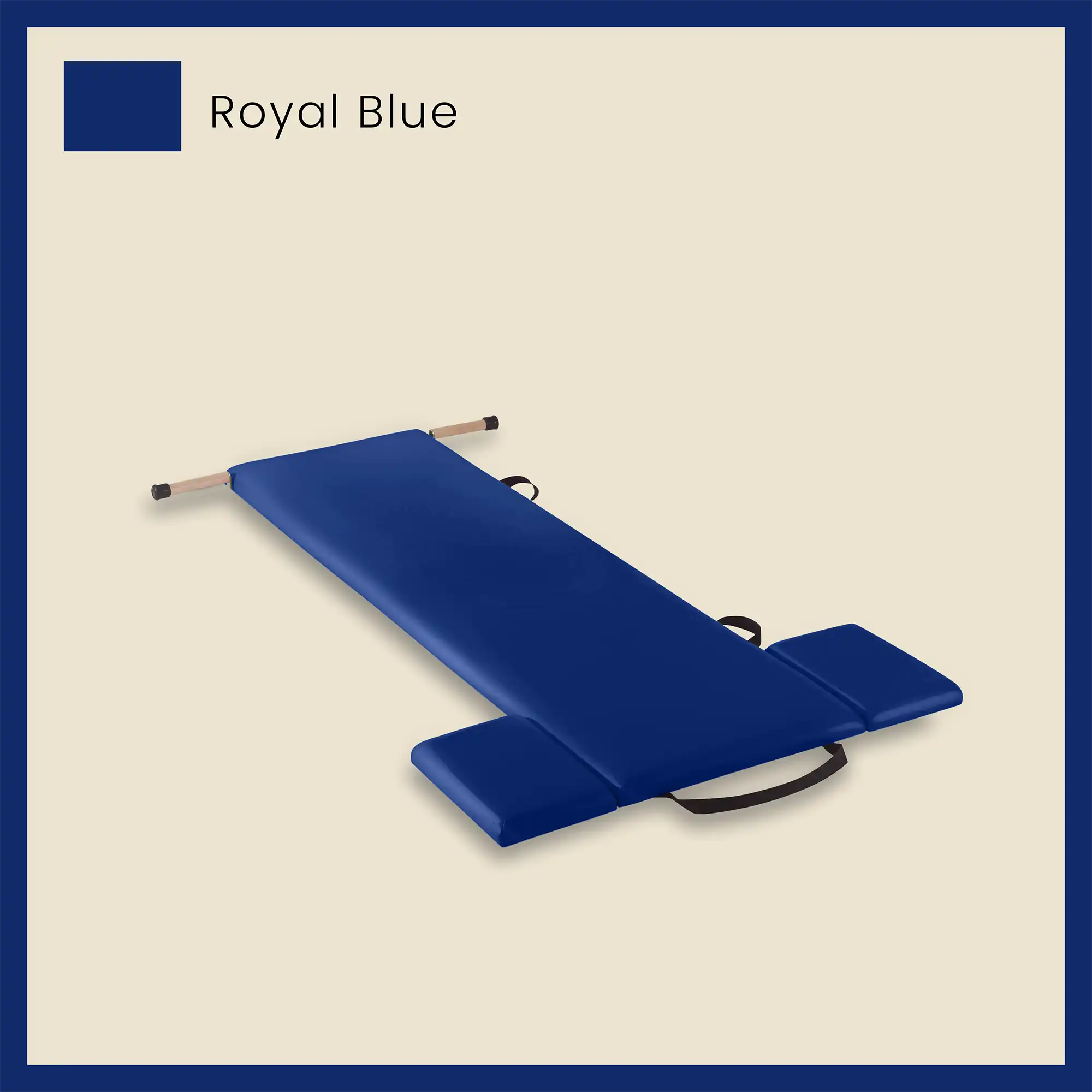Blue pilates mat in royal blue color with foot strap and side cushions on a neutral beige background.