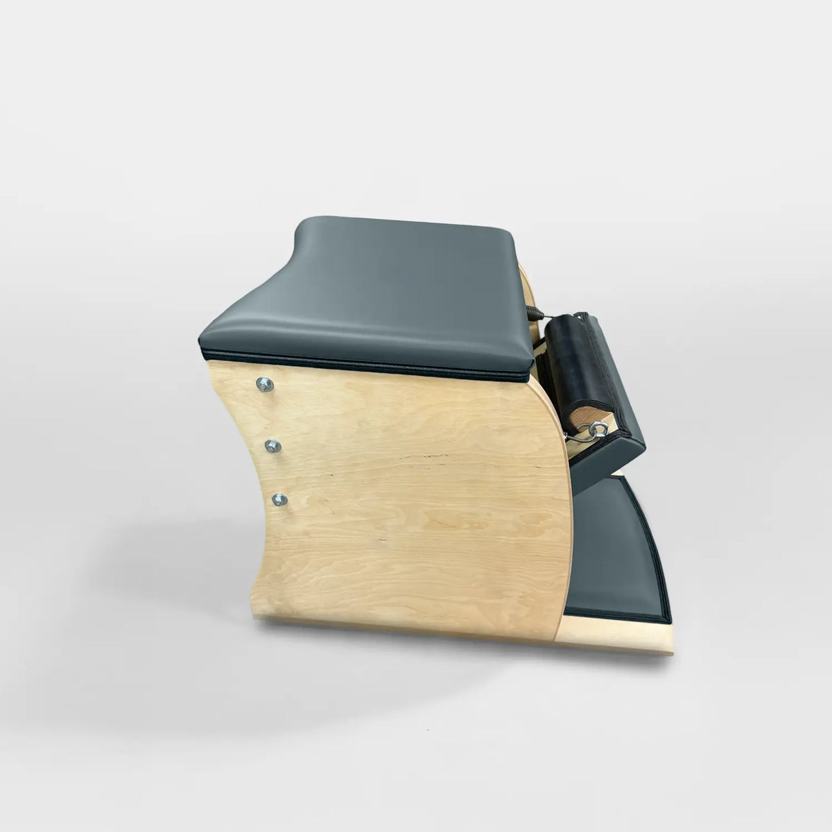 Gratz Pilates Wunda Chair in graphite gray leather with maple wood base and spring pedal.