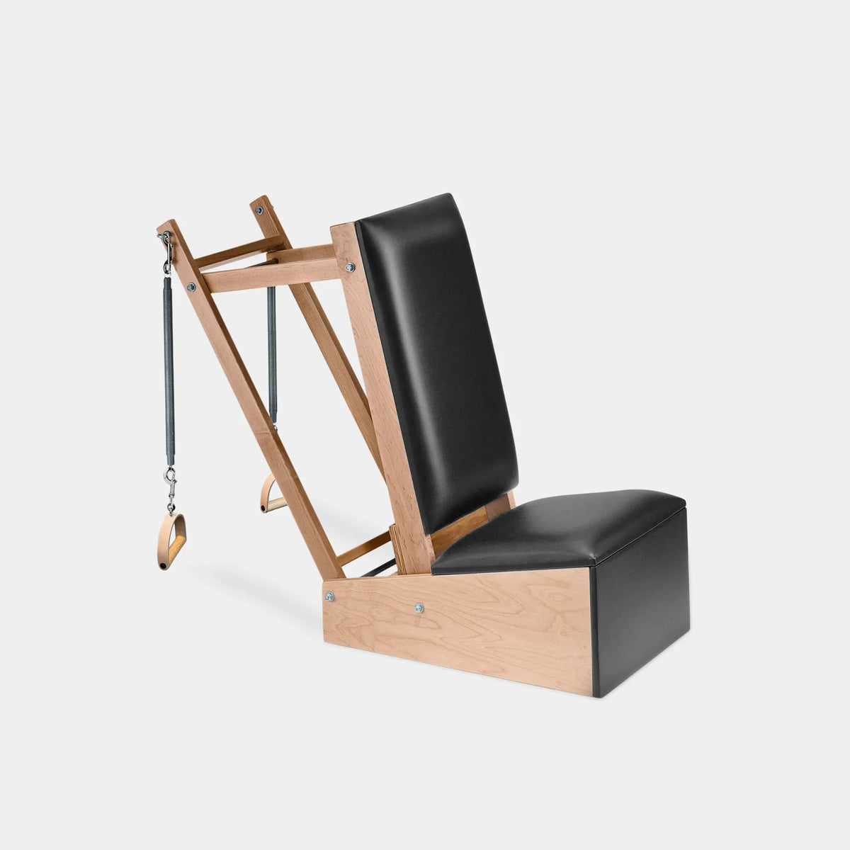 Gratz Pilates arm chair with black leather upholstery, wooden frame, and spring-loaded handles.
