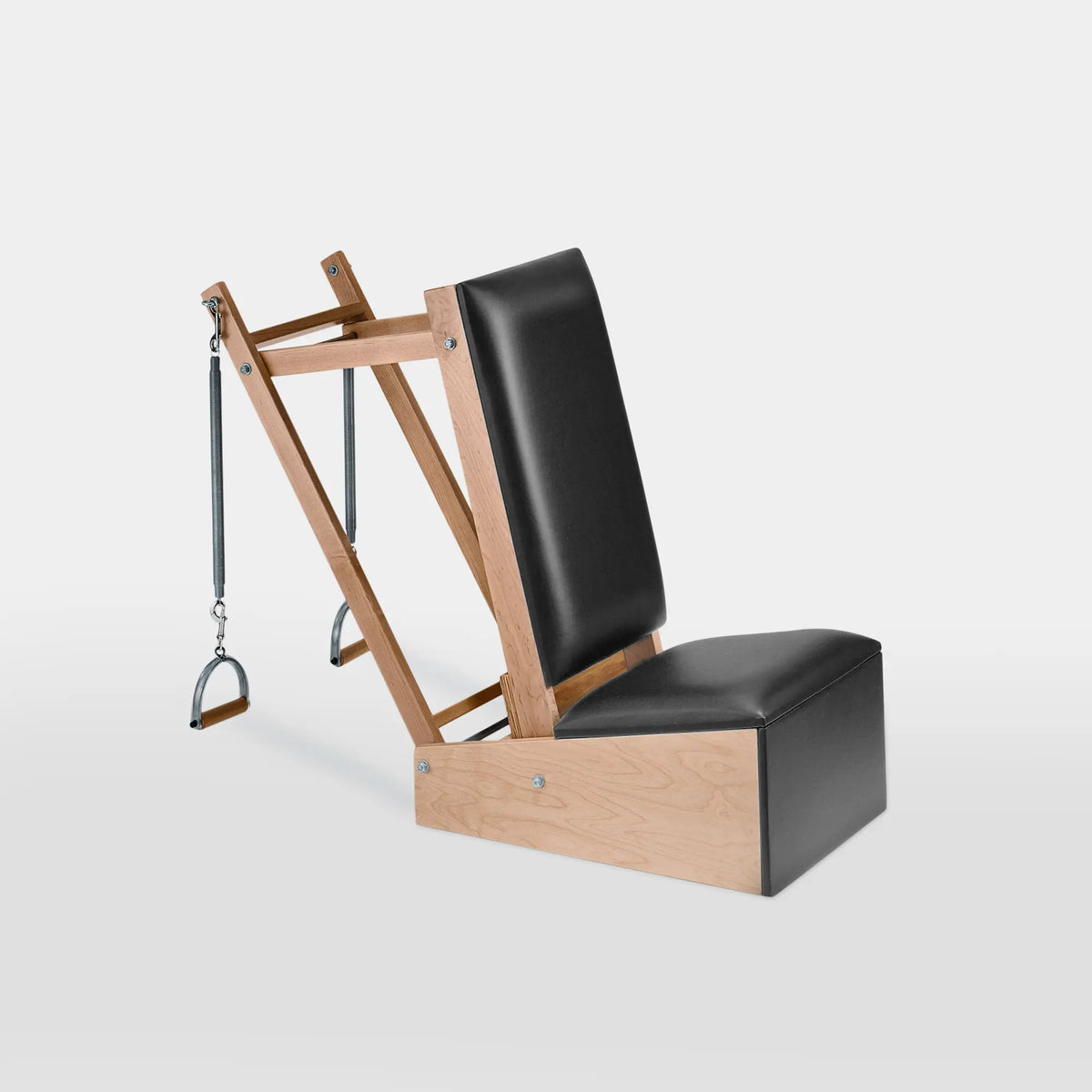 Gratz Pilates arm chair in black leather with wooden frame, spring-loaded handles, and metal loops.