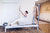 Korean Woman exercising on the Instant Half Cadillac Conversion in their studio. Text reads: "Lead time: 6 months"