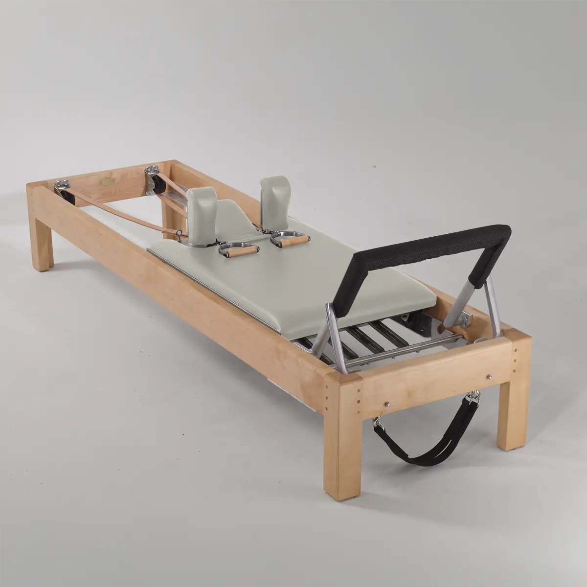 Gratz Pilates reformer with maplewood frame, alabaster leather carriage, shoulder blocks, and footbar.