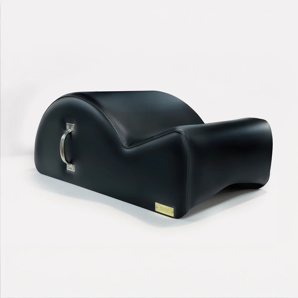 Gratz Pilates spine corrector in black leather with chrome carrying handle and brass nameplate.