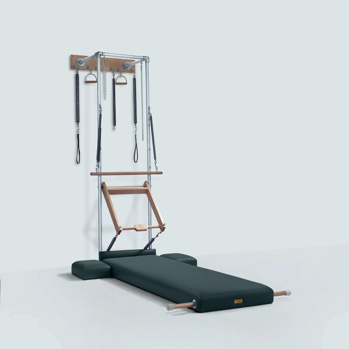 Gratz Pilates studio wall unit with springs, straps, push-through bar, and graphite high rigid mat.